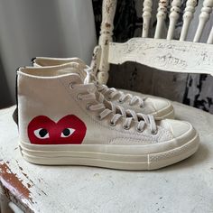 Wear Your Heart On Your Shoes With The Converse X Comme Des Garons Play Chuck 70 Sneaker. This Street-Ready Style Features The Premium Chuck Details You Know And Love, Paired With A Whimsical Heart-And-Eyes Graphic Peeking Just Above The Sole. Eye-Catching Is An Understatement. Why You Should Be Down: -Canvas Is Lightweight And Durable. -Tonal Rubber Toe Cap And Contrasting Heelstay For Standout Style. -Lace-Up Design For A Snug Fit. -Vulcanized Rubber Sole For Increased Traction. -Signature Hea Custom Canvas Sneakers With Boost Midsole, Converse Custom Sneakers With Red Sole, Casual Converse High-top Sneakers With Red Sole, Converse Custom Sneakers With Vulcanized Sole, Converse Canvas Sneakers With Round Toe, Converse Sneakers With Vulcanized Sole And Round Toe, Converse Sneakers With Vulcanized Sole, Converse Custom Low-top Sneakers With Red Sole, Casual Custom Sneakers With Red Sole And Round Toe