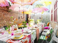 an outdoor dining area with tables, chairs and umbrellas