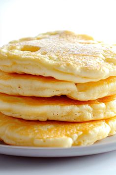 a stack of pancakes sitting on top of a white plate