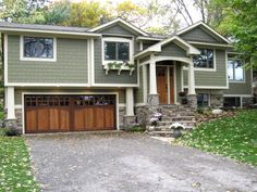 a large house with two garages in front of it