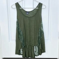 Wet Seal. Hi Low Lace Olive Green Tank Top. Brand New With Tags. Lace Strips Down The Tank In Various Areas. Perfect Condition. Size Small Bohemian Lace Trim Tank Top, Casual Tank Top With Lace Detail, Flowy Cotton Tops With Lace Trim, Casual Tops With Lace Trim For Layering, Casual Lace Trim Tops For Layering, Summer Lace Trim Tank Top For Layering, Green Casual Lace Top, Green Lace Trim Top For Vacation, Green Lace Trim Top For Beach