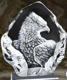 an eagle crystal award is displayed on a black and white marble base with silver accents