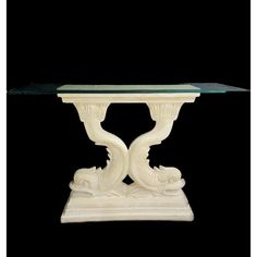 a white marble table with glass top on a black background in the style of art deco