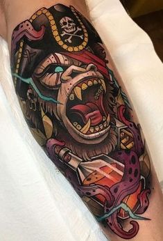 a man with a tattoo on his arm has a bear in the middle of it