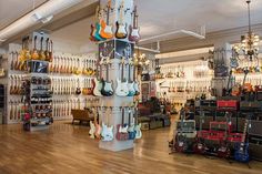 a room filled with lots of guitars and amps