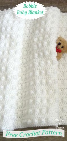 a crocheted baby blanket with a teddy bear on it