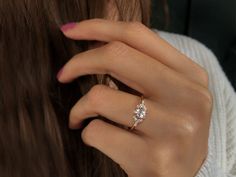 a woman's hand with a diamond ring on her finger