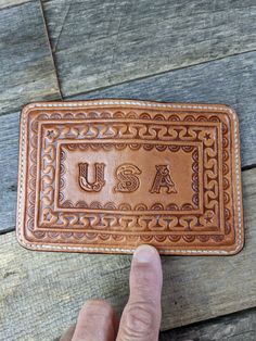 a handmade leather business card holder with the word usa on it