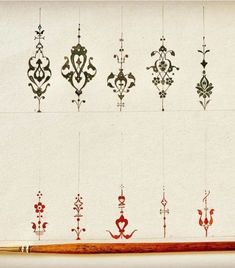 an assortment of ornamental designs are hanging on the wall in front of a white background