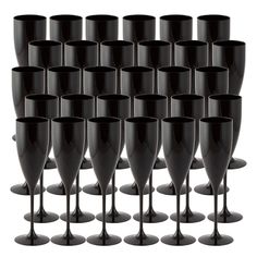 a bunch of black wine glasses lined up together