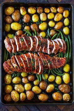 pork, potatoes and green beans in a roasting pan