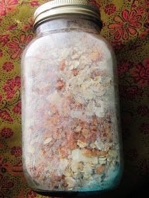 a glass jar filled with lots of different types of stuff on top of a table