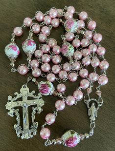 "This beautiful handmade rosary is made with 8mm glass beads, 10mm ceramic beads and 2\" crucifix. Length: 20\" inches long" Adjustable Pink Rosary Bracelet At Affordable Price, Handmade Pink Rosary Bracelet With Round Beads, Handmade Pink Rosary With Round Beads, Pink Beaded Spiritual Rosary, Pink Rosary With 8mm Beads For Gift, Pink Rosary With 8mm Beads As Gift, Pink Rosary With 8mm Round Beads, Pink Spiritual Rosary Bracelet With 8mm Beads, Pink Beaded Rosary With Round Beads