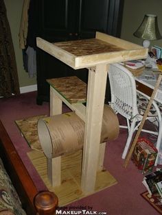 the table is made out of plywood and has a roll of toilet paper on it