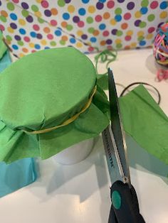 scissors are used to cut the top of a turtle's hat