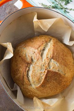 a loaf of bread sitting inside of a metal pan