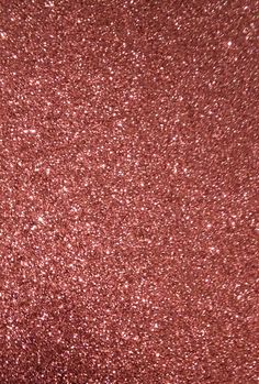 a close up view of a red glitter background