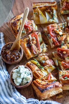 a wooden cutting board topped with slices of pizza