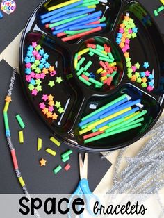 a black tray with colorful sticks in it and the words space crafts written on it