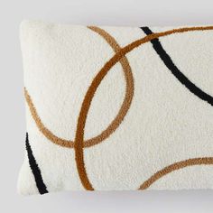 a white pillow with brown and black circles on it