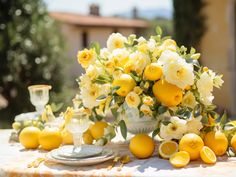 a table topped with lemons and white flowers