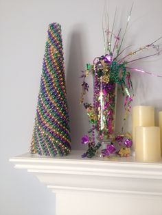 a christmas tree and candles on a mantle