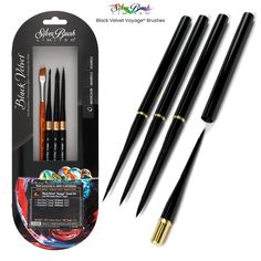 three black and gold colored pens in a box with the packaging on it's side