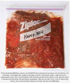 a ziploc bag filled with red sauce and meat on top of a white table