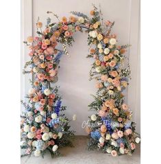 two floral archways decorated with flowers and greenery