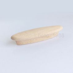 a wooden object on a white surface with no one in the photo looking at it