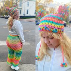 two women wearing knitted hats and colorful pants on the side of the road in front of a white house