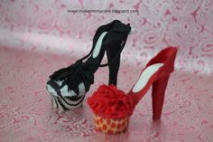 a cupcake and high heel shoes on a table