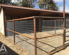 an animal pen with metal fencing around it