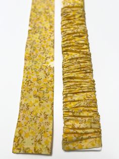 two pieces of yellow fabric sitting next to each other