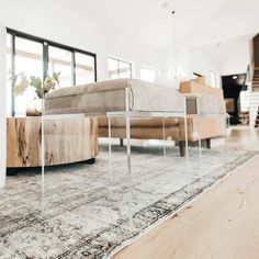 a living room with a couch, coffee table and rug