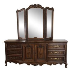 an antique dresser with mirrors and drawers