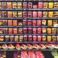 a display in a grocery store filled with lots of different types of fruits and vegetables