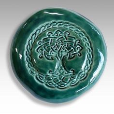 a green plate with an intricate design on it