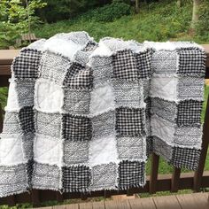 a black and white checkered blanket on a wooden deck