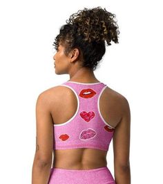 ABOUT Get ready to pucker up in this Valentine's Day-inspired sports bra! With a playful kiss print and comfortable fit, this bra will keep you supported and stylish during your workouts. Show off your fun and flirty side while staying active. (No puckering required!) Crafted with a breathable mesh fabric and unique cut-out design, this bra ensures maximum ventilation and comfort. The supportive straps and ribbed band provide added strength and stability, allowing you to reach your workout goals Playful Fitted Sports Top, Pink Athleisure Activewear For Cheerleading, Playful Pink Activewear For Workout, Trendy Workout Fitted Bra, Trendy Fitted Workout Bra, Playful Pink Fitted Activewear, Trendy Pink Sports Bra, Trendy Pink Sports Bra With Built-in Bra, Trendy Pink Sports Bra For Workout