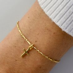 A beautiful dainty bracelet with a tiny Cross charm. What a beautiful gift for people of faith. We are carry these beautiful bracelets in two adjustable sizes, 6 1/2 inch and 7 1/2 inch, both with a 1 inch extension added to tailor your fit perfectly. Custom sizes are also available upon request :). To find your size, measure your wrist with a string adding a fingers width in there for some slack. Then lay the string on a ruler to determine your size. We use only the highest quality materials, I Gold Cross Bracelet, Jewelry Gold Bracelet, Expensive Jewelry Luxury, Tiny Cross, Beautiful Bracelets, Gold Armband, Beads Bracelet Design, Dainty Bracelet, Classy Jewelry