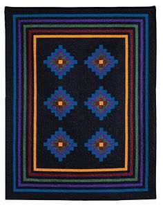 a black quilt with multicolored squares on it