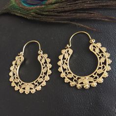 Hoops Earrings in Silvered or Golden Brass Serrated and Openworked. These Earrings are Elegantly Decorated with Openwork Plant and Floral Motifs to Create a Pretty Mandala. The Inner and Outer Perimeter is Serrated to Give these Creoles a More Ethnic Style. These Hoop Earrings are very elegant and they will illuminate your face. Timeless and Lightweight Creoles to Wear Everyday to Give an Ethnic Touch to Your Outfits. They are made from brass. Material: Brass Color: Silver or Gold Length: 4.6cm Width: 3.8cm Thickness: 0.2 cm Weight: 10 Gm (The Pair) Handmade Delivered in a Fabric Pouch Ideal for Gifting To offer or simply treat yourself, do not hesitate! You Can Match Them With This Item: https://www.etsy.com/fr/listing/1356743284/bracelet-adjustable-dore-avec-pierre-semi?ref=listings_mana Festival Dangle Hoop Earrings With Latkans, Bohemian Dangle Hoop Earrings With Latkans, Festive Metal Hoop Earrings With Intricate Design, Ornate Hoop Earrings For Festivals, Festive Brass Hoop Earrings With Intricate Design, Traditional Metal Hoop Earrings With Intricate Design, Traditional Hoop Earrings With Intricate Design, Traditional Hoop Earrings With Intricate Metal Design, Ornate Gold Hoop Earrings For Festivals