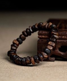 The exquisite Retro Brown Sandalwood Buddha Beads Bracelet is a true work of art, exuding an air of sophistication and exclusivity. Handcrafted with precision and attention to detail, this bracelet boasts a timeless appeal that is reminiscent of old-world luxury. The warm hues of brown sandalwood perfectly complement the intricate Buddha beads, making it a must-have accessory for the discerning fashion connoisseur. Elevate your style with this exquisite bracelet and embrace the elegance it exude Brown Wooden Bracelets With Round Beads, Brown Wooden Bracelet With 8mm Beads, Brown Wooden Beaded Bracelets As A Gift, Natural Wood Beaded Bracelets For Gifts, Natural Wood Beaded Bracelets As Gift, Brown Wooden Beaded Bracelet As A Gift, Natural Wood Beaded Bracelet As Gift, Brown Wood Beaded Bracelets, Brown Wooden Beaded Bracelets With 8mm Beads