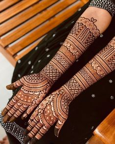 two hands with henna designs on them