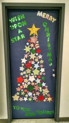 a christmas tree made out of paper with writing on the front and bottom door,