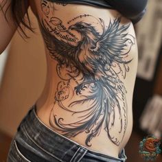 a woman's stomach with an eagle tattoo on it