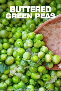 a wooden spoon filled with green peas and the words buttered green peas above it