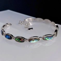 Sterling silver Abalone Shell bracelet, adjustable length from 16.5cm to 22cm.  Please contact me if you need a different length which I will be able to do it within 2-3 days. 💎Natural, handpicked Abalone Shell 💎 Sterling Silver 💎Adjustable - 16.5cm to 22cm Due to the natural colouring of the shell the pattern/colour can vary. We will try our best to select the most beautiful colours available. Rhodium-plated silver is fine sterling silver that is polished and dipped in rhodium. It has a brig Adjustable Oval Sterling Silver Bracelet With Oyster Design, Adjustable Oval Sterling Silver Oyster Bracelet, Rectangular Adjustable Sterling Silver Bracelet Gift, Adjustable Rectangular Sterling Silver Bracelet Gift, Adjustable Oblong Jewelry As A Gift, Abalone Shell Bracelet, Shell Bracelet, Beautiful Colours, Pretty Rings