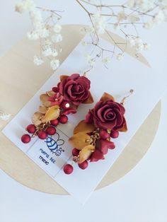 https://purplebeestudio.etsy.com Handmade botanical-inspired polymer clay earrings in gorgeous Rustic Red colour. The roses, flowers and leaves are handmade by me with a great care to the detailes without using any molds. These very elegant, delicat earrings will become your favorits for many occasions day or night. Perfect gift for a special woman in your life. Earrings made with brass ear wire. The earrings are very light and comfortable to wear all day. SHIPPING: Your order will be dispatched in a securely packed cardboard box. Product care:  - To ensure the product quality and durablility, avoid contact with water, lotion, perfumes and household cleaners and chemicals. - You can clean the products with a slightly damp soft fabric.  - Sharp objects can damage the clay surface. - When no Handmade Flower Earrings In Polymer Clay, Elegant Handmade Flower Polymer Clay Earrings, Elegant Handmade Flower Earrings In Polymer Clay, Clay Chandelier, Red Rose Earrings, Gold Bead Earrings, Long Flowers, Botanical Earrings, Black Earrings Dangle